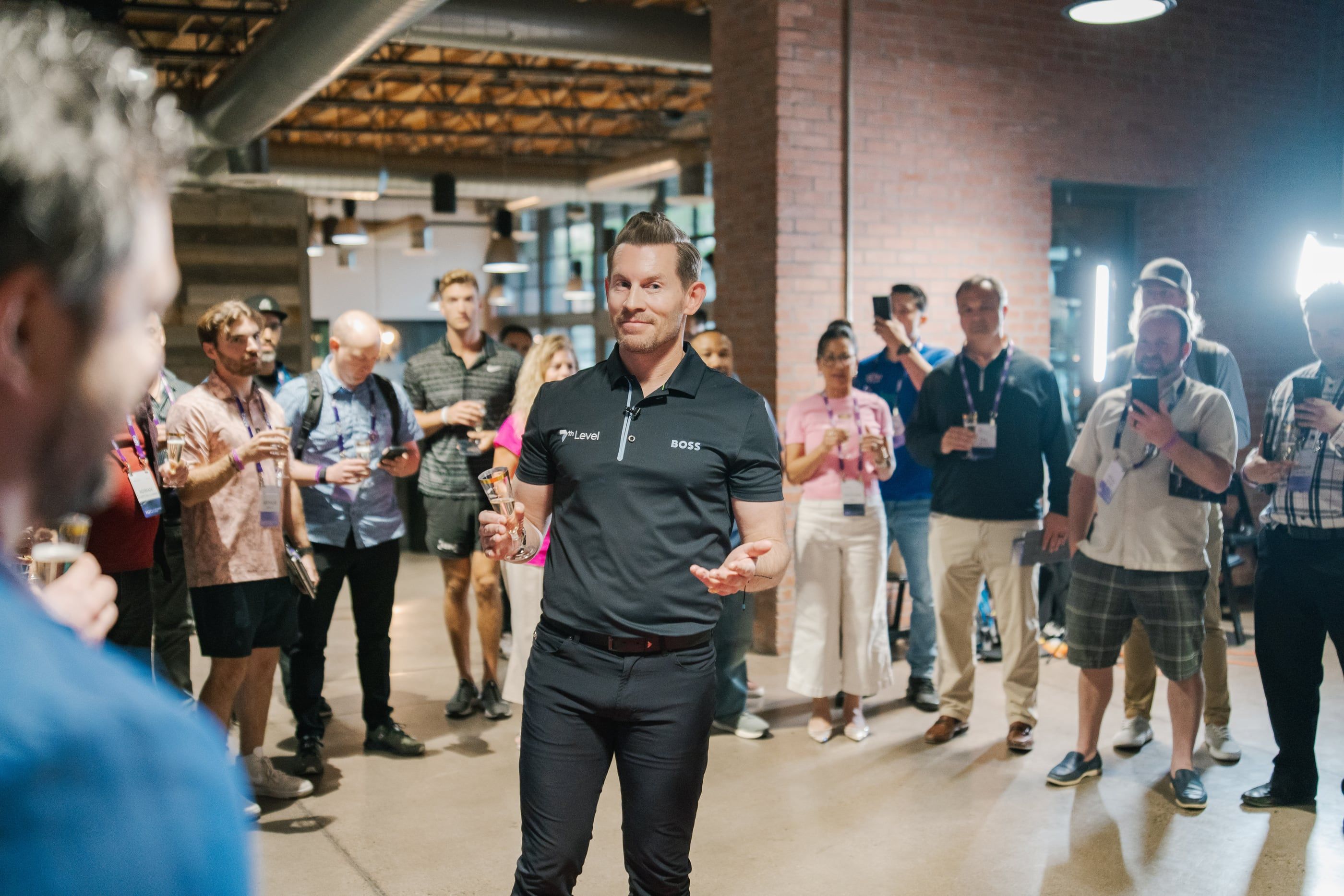 Jeremy Miner talking with a standing circle of attendees at an evening session